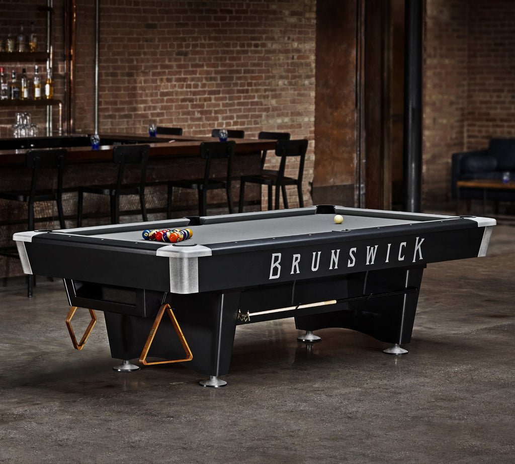 Brunswick Billiards BLACK WOLF Pro 7' Pool Table set up in a room with brick walls.
