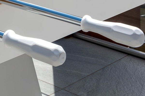 Two white handles on a Kettler FAS Ciclope Outdoor Foosball Table with sleek metal rods.