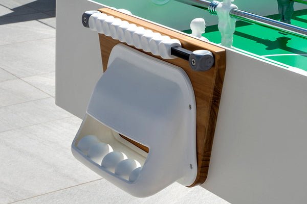 Close-up of a Kettler FAS Ciclope White Outdoor Foosball Table with cover and balls included.