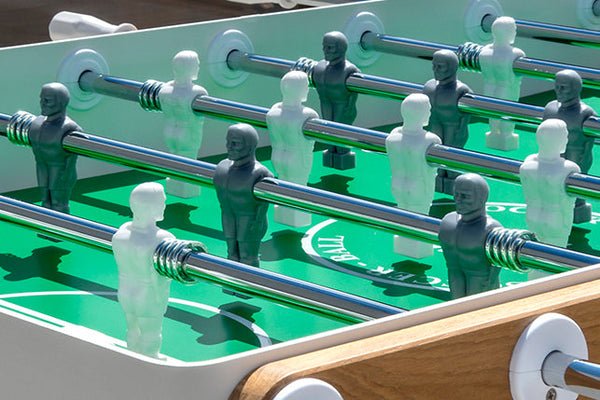 Close-up of a Kettler FAS Ciclope White Outdoor Foosball Table with cover and balls included.