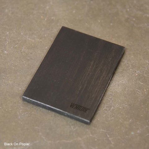 A black-stained wood piece from the Venture Grand Deluxe 9' Shuffleboard Table.