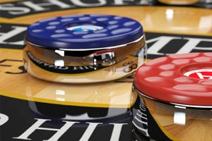 Close-up of pucks on the Champion Reagan 16' Shuffleboard Table with custom options.