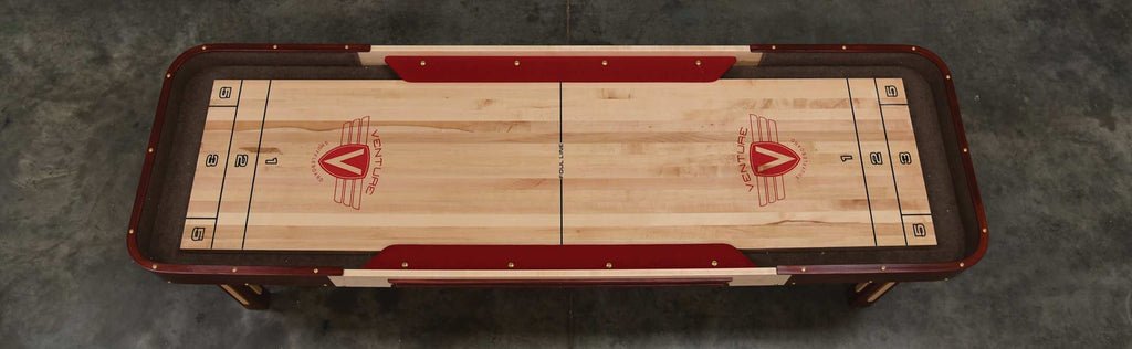 Overhead view of a Venture Grand Deluxe Bank Shot 9' Shuffleboard Table on concrete floor.